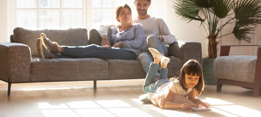 Warme huiskamer met meisje dat op de grond speelt in een goed geïsoleerd huis"